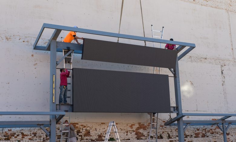 Installation of a 6.667mm pixel pitch 10' x 16' LED display comprised of two pre-assembled sections of modular cabinets that combine to create a more complex and larger LED display. (Photo credit: Hilton Digital)