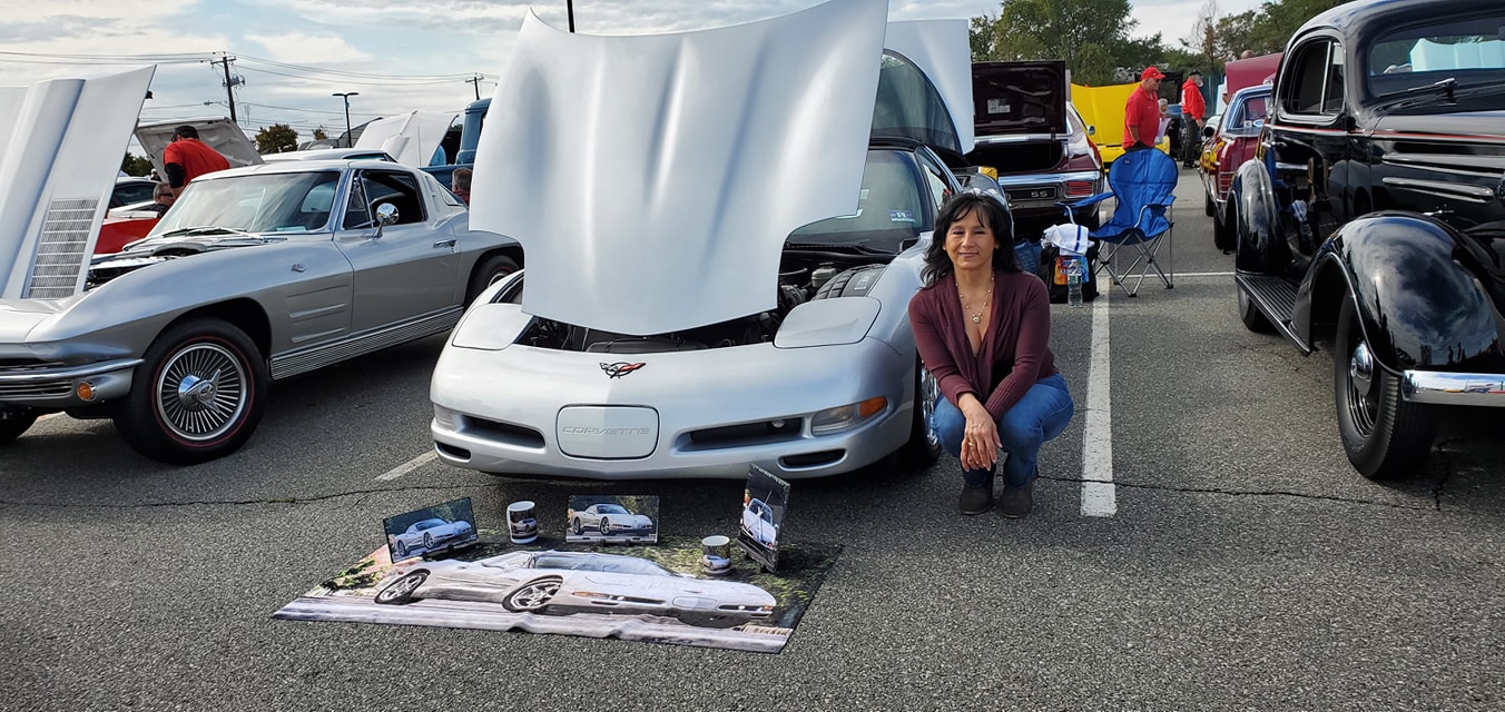 Martha Ray poses with Michael Kaminsky's corvette. 