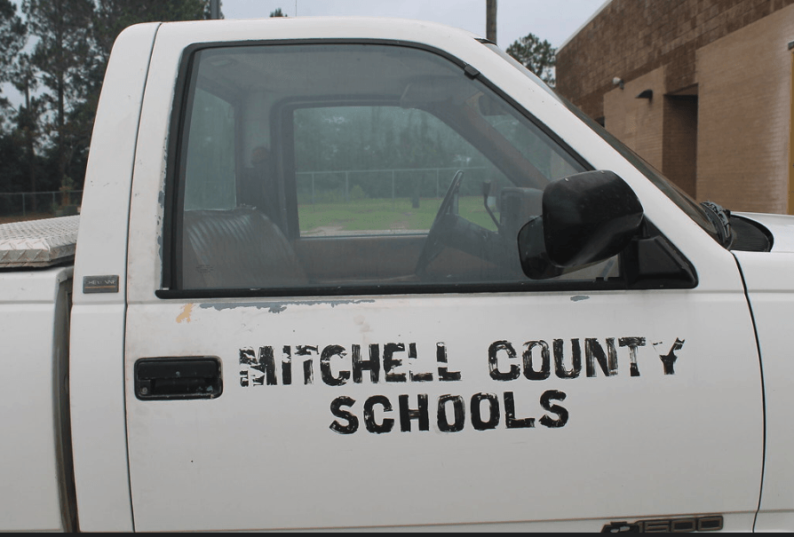 The maintenance truck at the high school had seen some wear and tear over the years.