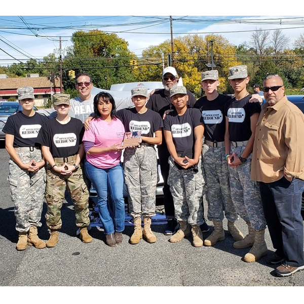 Sublimation101 Martha Ray and Michael Kaminsky stand with members of Operation Rebound, an organization for veterans. (Image courtesy Sublimation101)