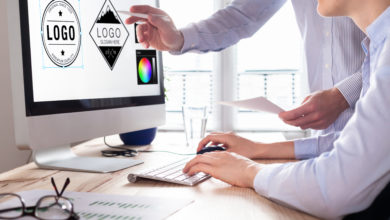 Designer team sketching a logo in digital design studio on compu