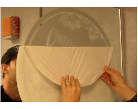 Justin Pate applies a frosted film spot graphic