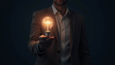 a man holds a light bulb in front of him in a dark room with discipline written on it
