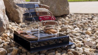 engraved pocket knives on a stand