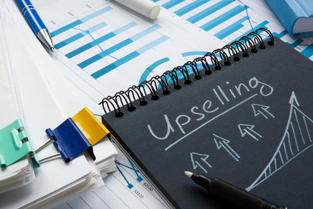 Q1 sale The inscription Upselling on a black notepad that lies on financial calculations.