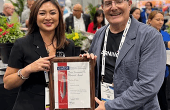 Susan Cox (left) receives the award. (Image courtesy of LogoJET)