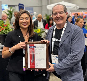 Susan Cox (left) receives the award. (Image courtesy of LogoJET)