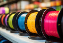 Multicolored filaments of plastic for printing on 3D printer close-up. Spools of 3D printing motley different colors thermoplastic filament. Motley ABS wire plastic for 3d printer. Additive technology