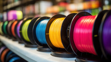 Multicolored filaments of plastic for printing on 3D printer close-up. Spools of 3D printing motley different colors thermoplastic filament. Motley ABS wire plastic for 3d printer. Additive technology