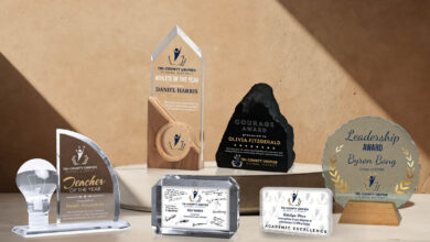 awards on concrete platform in front of a brown wall with sunlight shadows