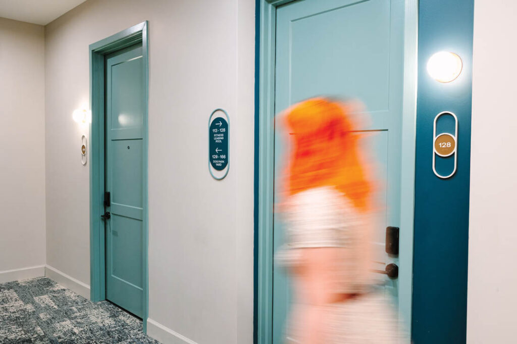 Wayfinding Directional and Unit Signs in a Corridor Photo Taken by Megan Morales