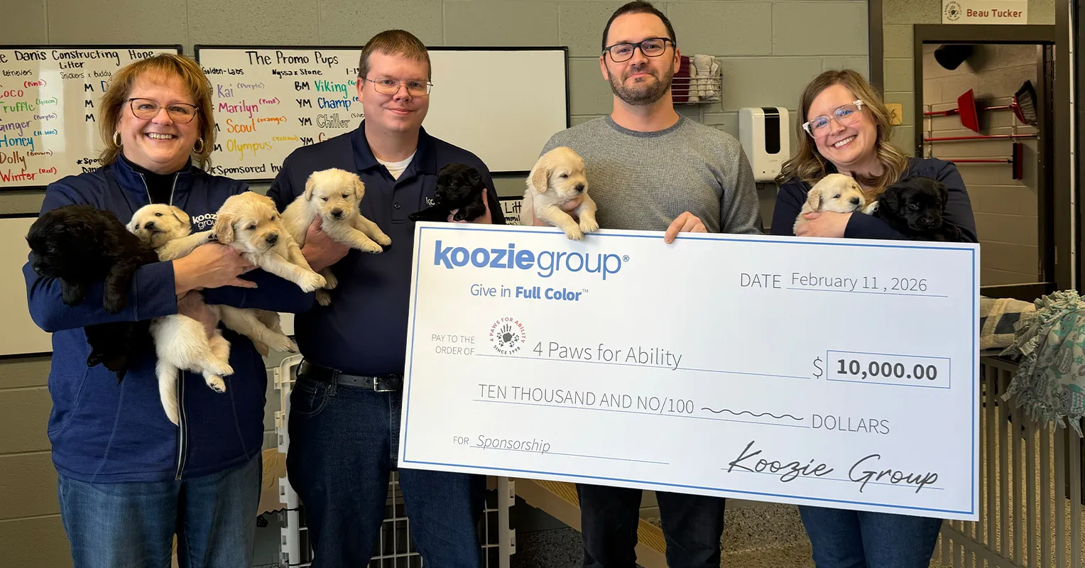 Koozie Group staff with puppies