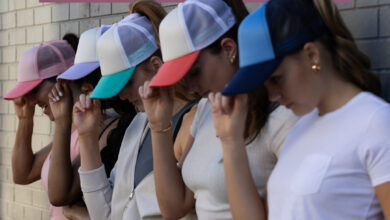 row of women wearing caps Images courtesy of Infinity Her