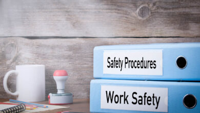 Work Safety and Safety Procedures. Two binders on desk in the office. Business background.