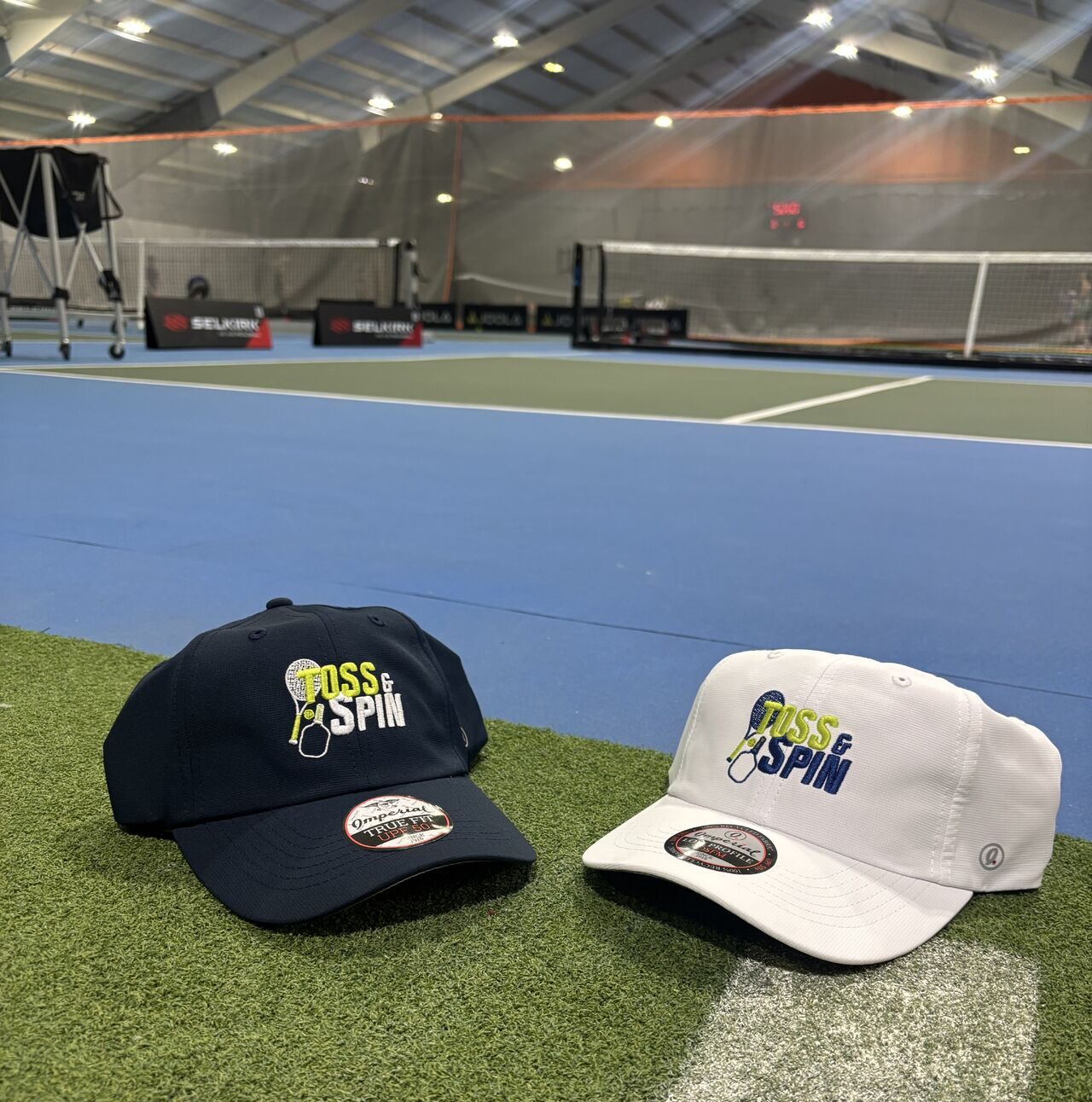 toss & spin branded hats on a pickleball or tennis court