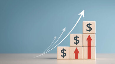Interest finance or mortgage rates. Wooden blocks with currency symbols and arrow pointing up icons. Financial growth, Deposit interest increase, inflation, sale price and dollar exchange rate rise.