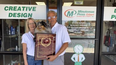 Minuteman Press Franchise Owners Angel & Dave Rindfleisch (with Balee) celebrate their President’s Club Award outside their center in Gilbert, AZ.