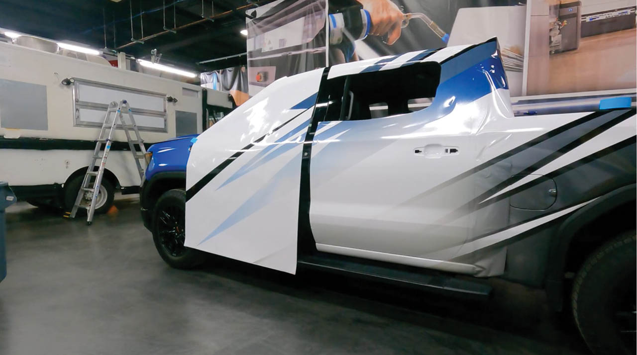 Anderson Image 4 Vinyl Images sets up a full vehicle wrap on this work truck AD Public 1