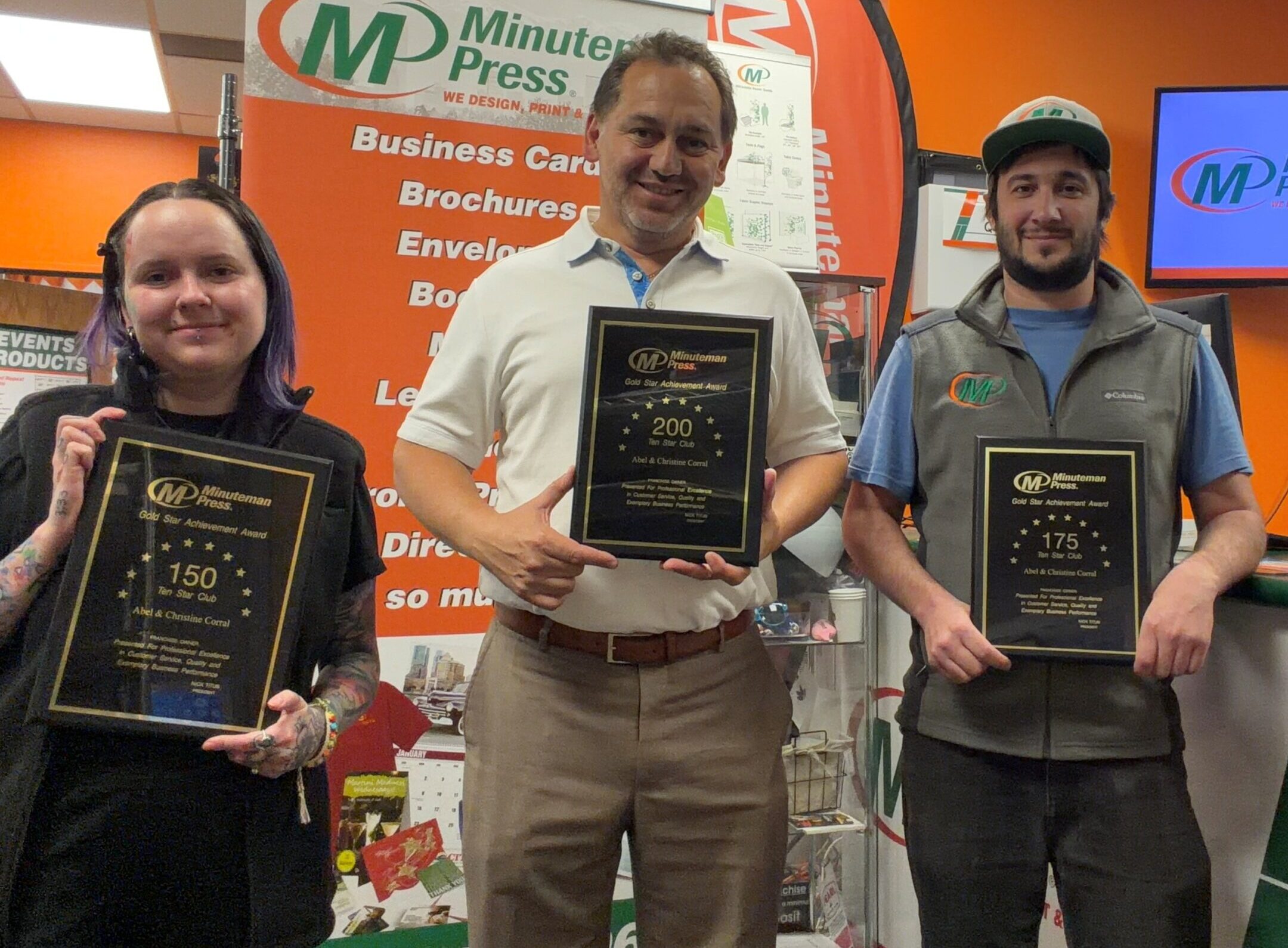 Minuteman Press Franchise Owner & President’s Club Member Abel Corral (center) with team members Mariah (left) and Jesse (right) in Denver, CO.